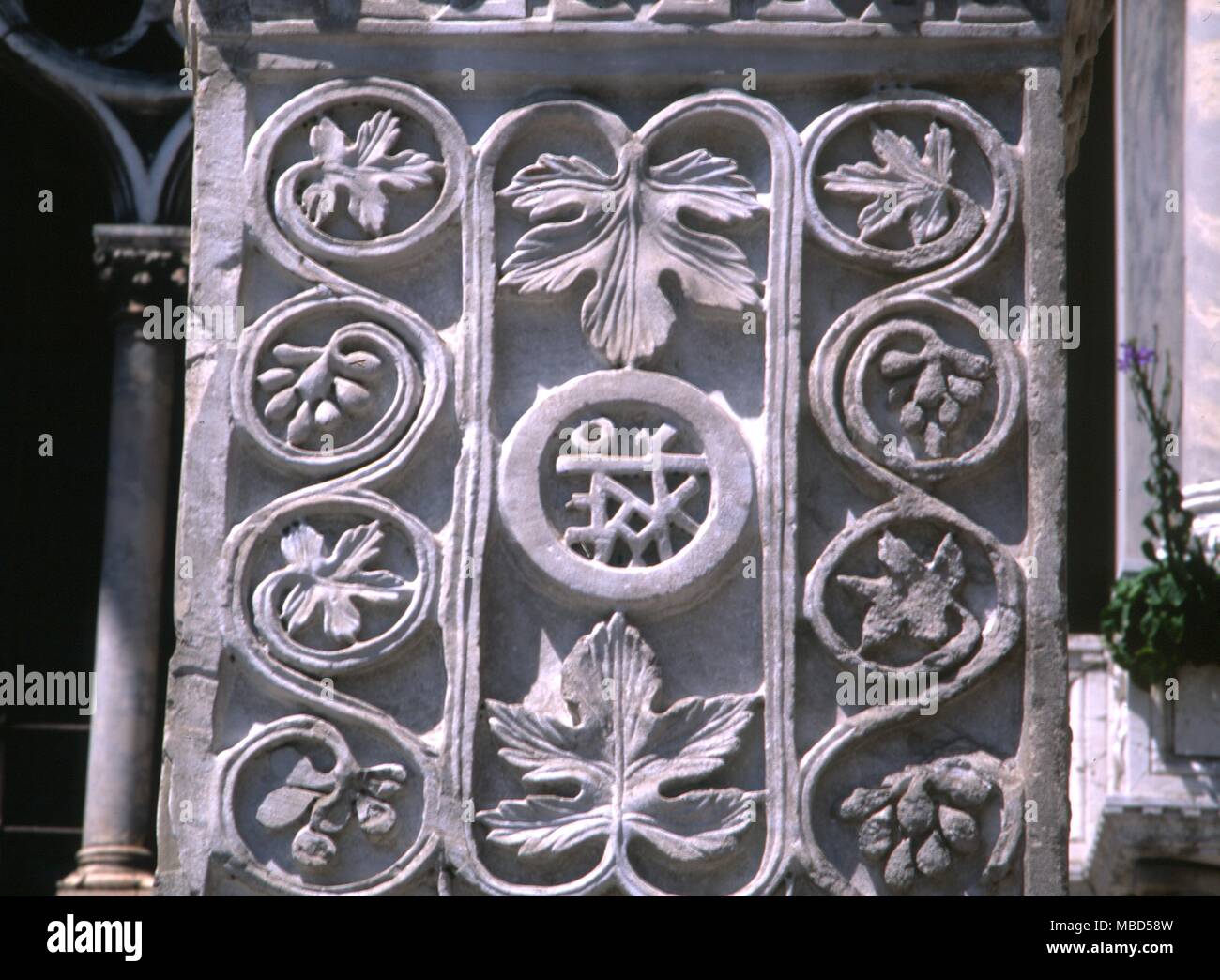 Symbols - Vine leaves. Vineleaves and monogram, probably brought to Venice from Constantinople. Now set in the wall of St. Marks. Italy Stock Photo