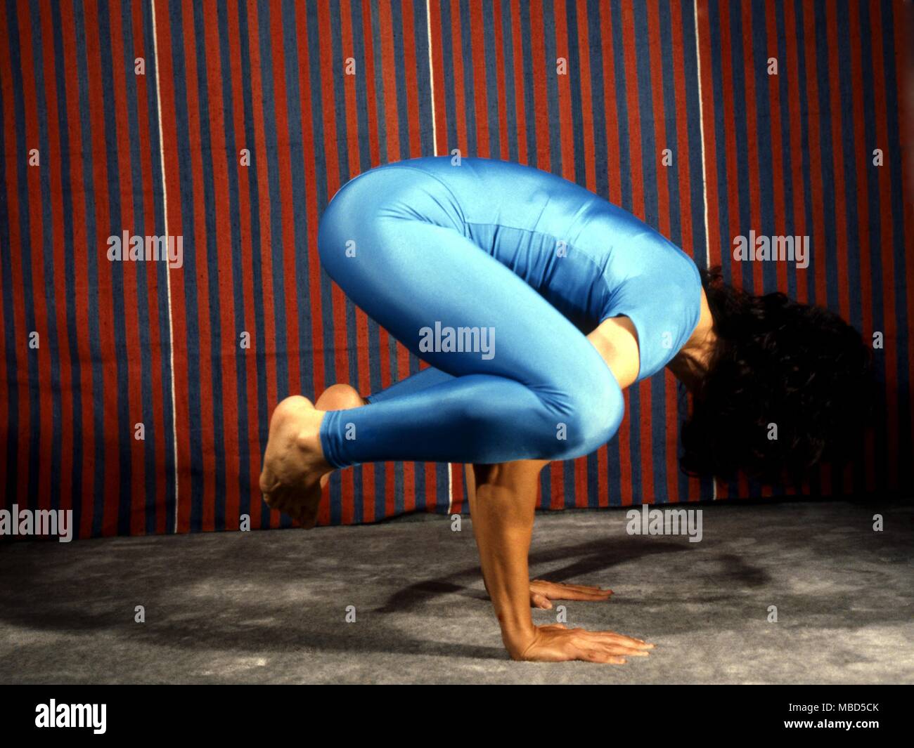 Yoga positions. The Crow or Kakasana Stock Photo