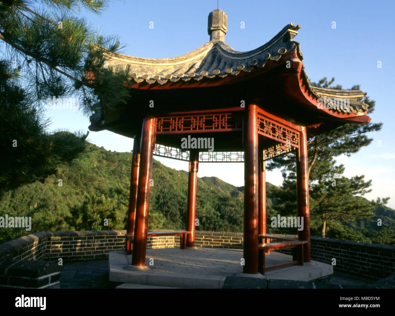 Feng Shui Chinese pavilion on hill top, its form completing the ' dragon ' shape of the hill as required by perfect Feng Shui. The pavilion is located near the Great Wall, north of Beijing Stock Photo