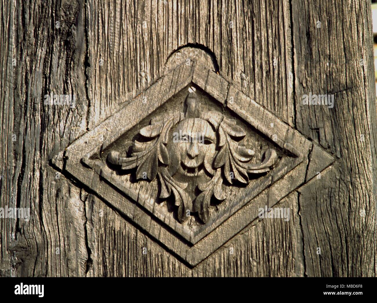 Wooden relief carving of Green Man on the exterior wall of Samlesbury Hall, one of the many haunted houses of Britain . Stock Photo