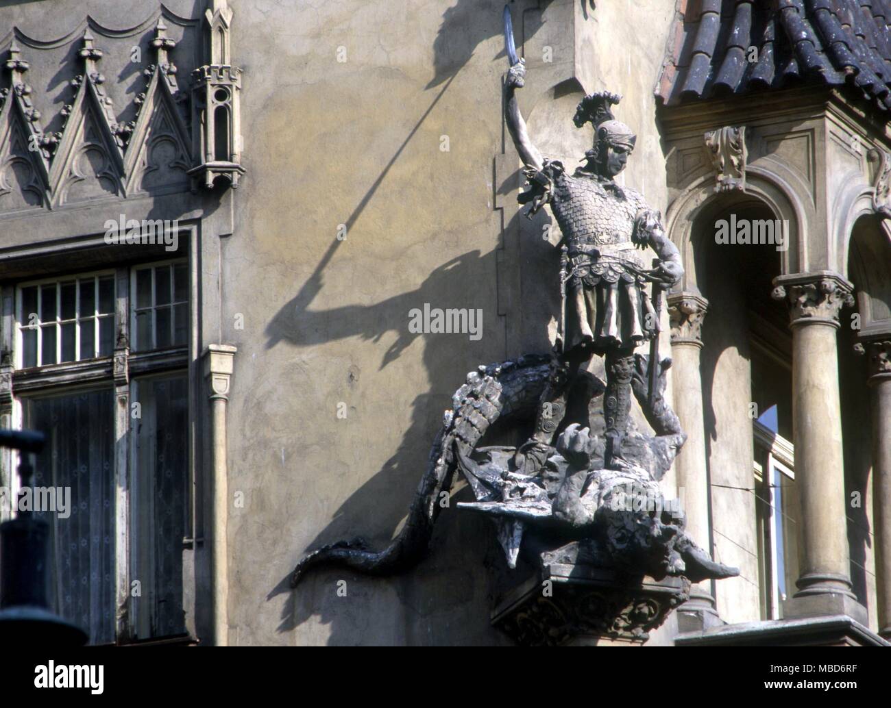 DRAGON - Knight killing dragon - perhaps St George and the dragon. Decorative sculpture on facade-corner of a house in Prague near the Old Town Centre. Stock Photo