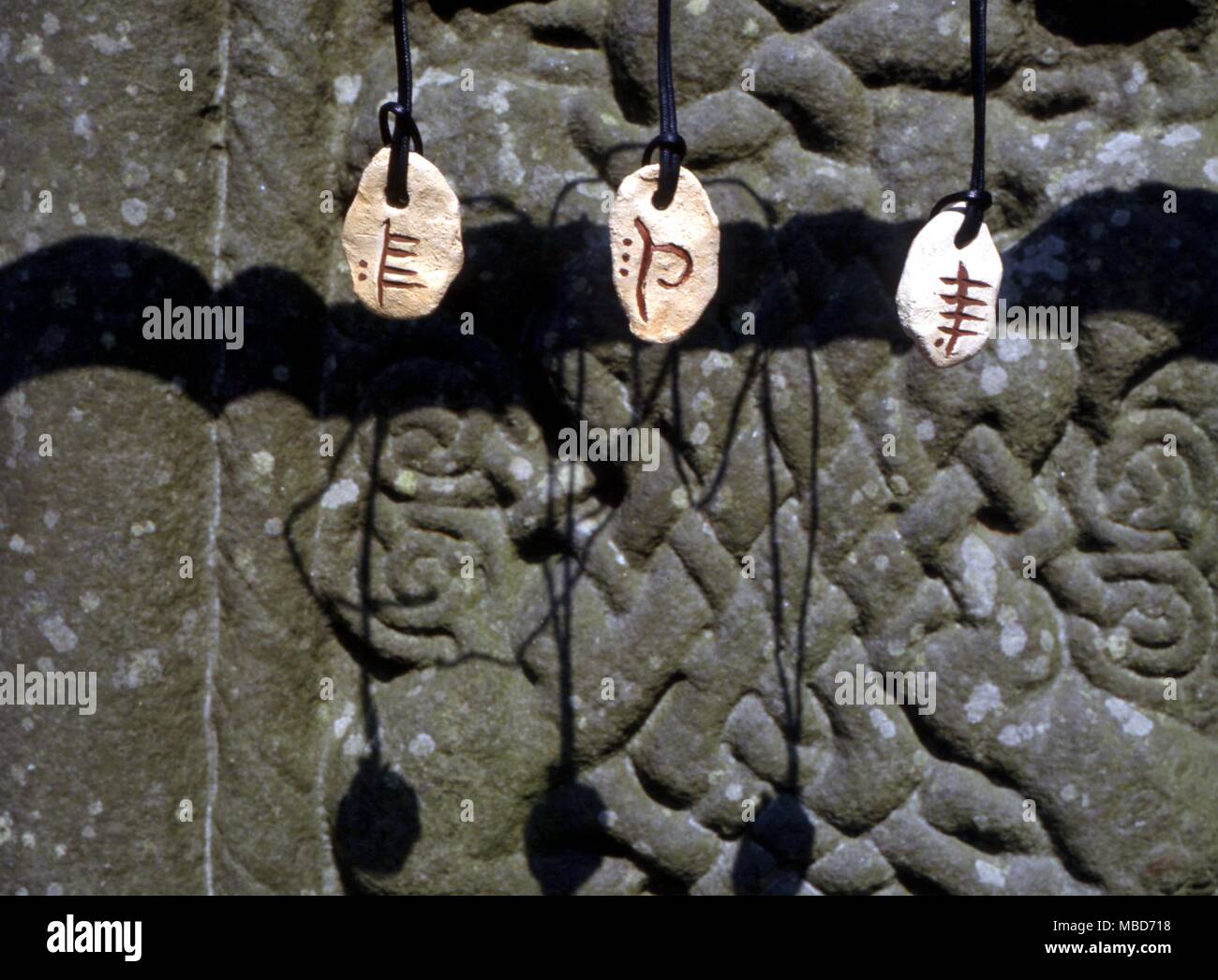 Celtic - Ogham Stones - from left to right - February (Willow) Earth (Beech, the Phagos) and Water (Poplar ). Hanging near the socle of the Southern Cross at Monasterboice, Ireland - The ogham alphabet is said to have originated in the fourth or fifth century in southern Ireland. It is widely regarded as the oldest alphabet used in Ireland. The alphabet takes its name from Ogma the ancient Celtic god of elocution or fine speech. It was Ogma, as legend has it, who inspired this alphabet. The main twenty letters in this alphabet are divided into four categories of five sounds (see Alpha Stock Photo