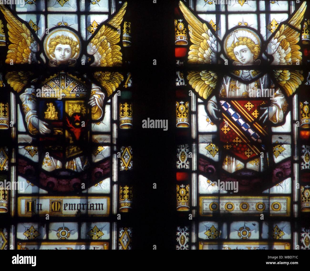 Two angelic armorial bearers in a side-chapel. Stained glass (19th century) from Lincoln Cathedral Stock Photo