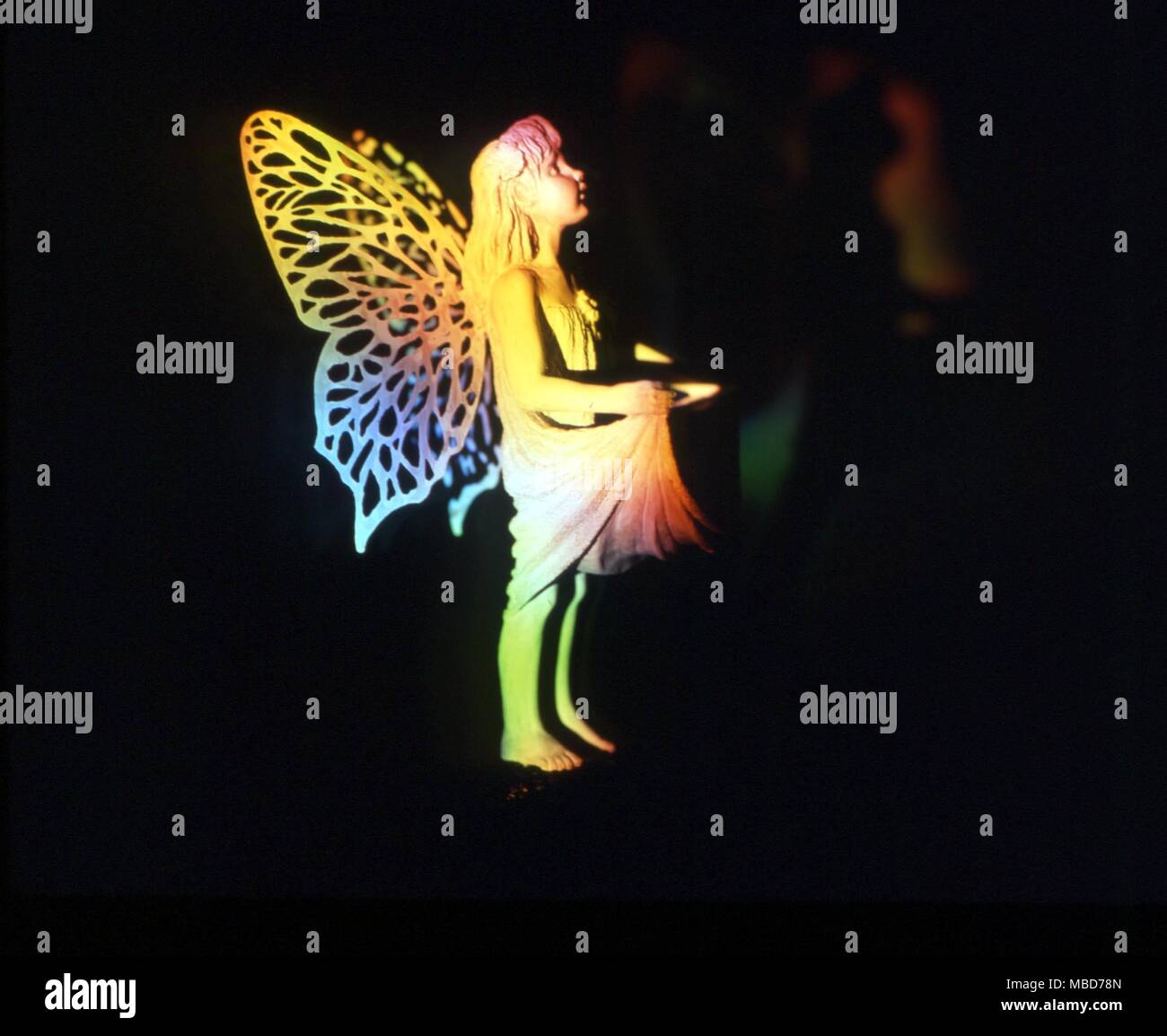 Fairies - Ethereal flower fairy against a dark background Stock Photo