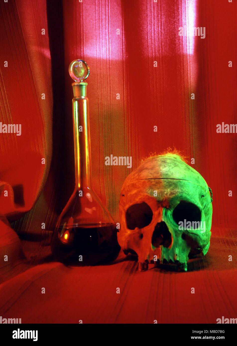 Skull and blood. The blood of a sacrificial victim is regarded as haivng an extraordinary power (for evil), and the black magician frequently resorts to thi liquid in order to exercise power. Stock Photo