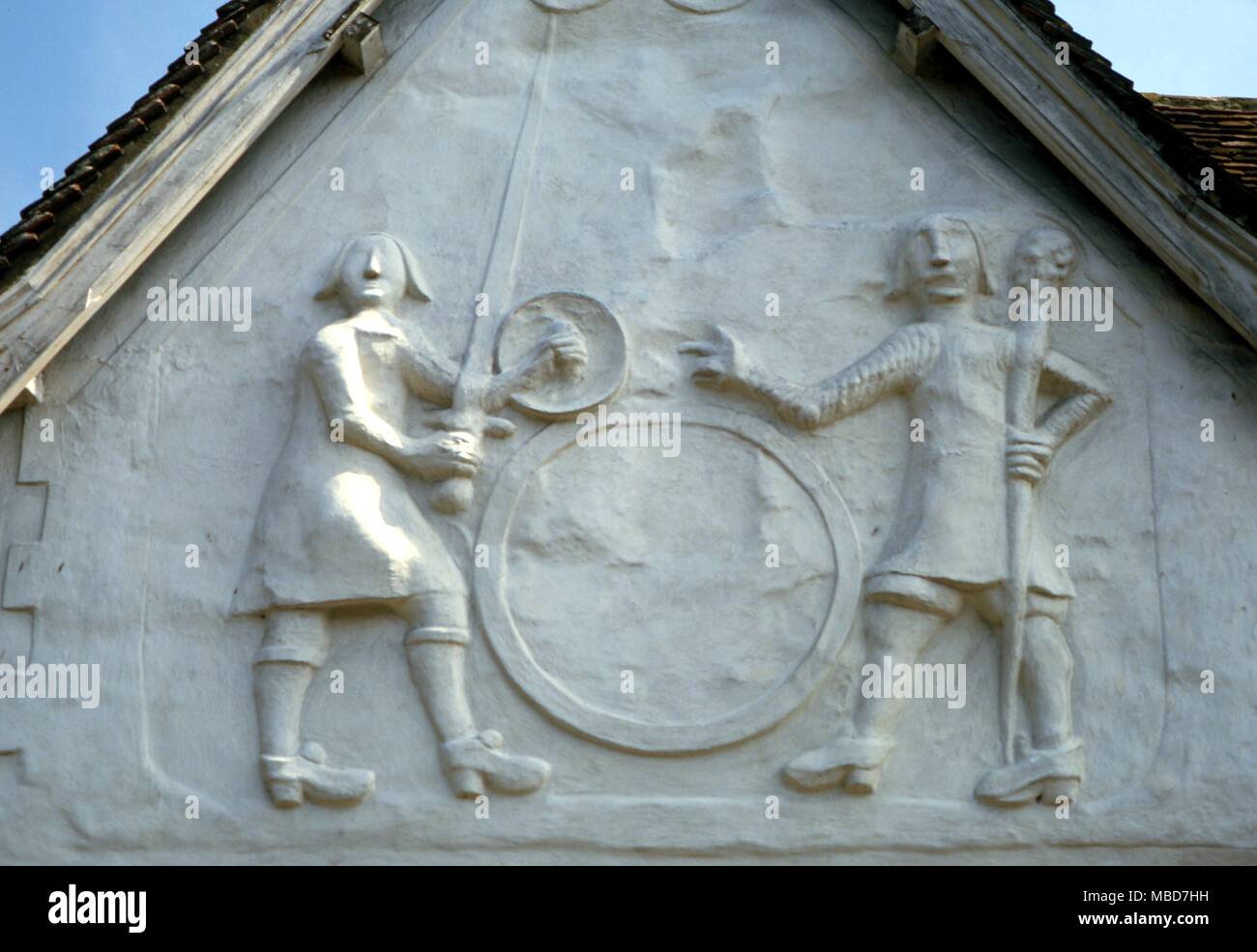 GIANT Gog and Magog. The giant heroes, Gog and Magog, in pargetting on the facade of the old Sun Inn, Saffron Walden. The fall of the sunlight on these figures reveal various hidden symbols Stock Photo