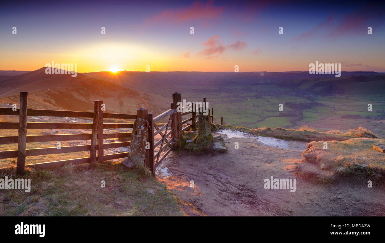 Spring Sunrise on Mam Tor overlooking Edale and the Hope Valley after a clear night with a light dusting of snow Stock Photo