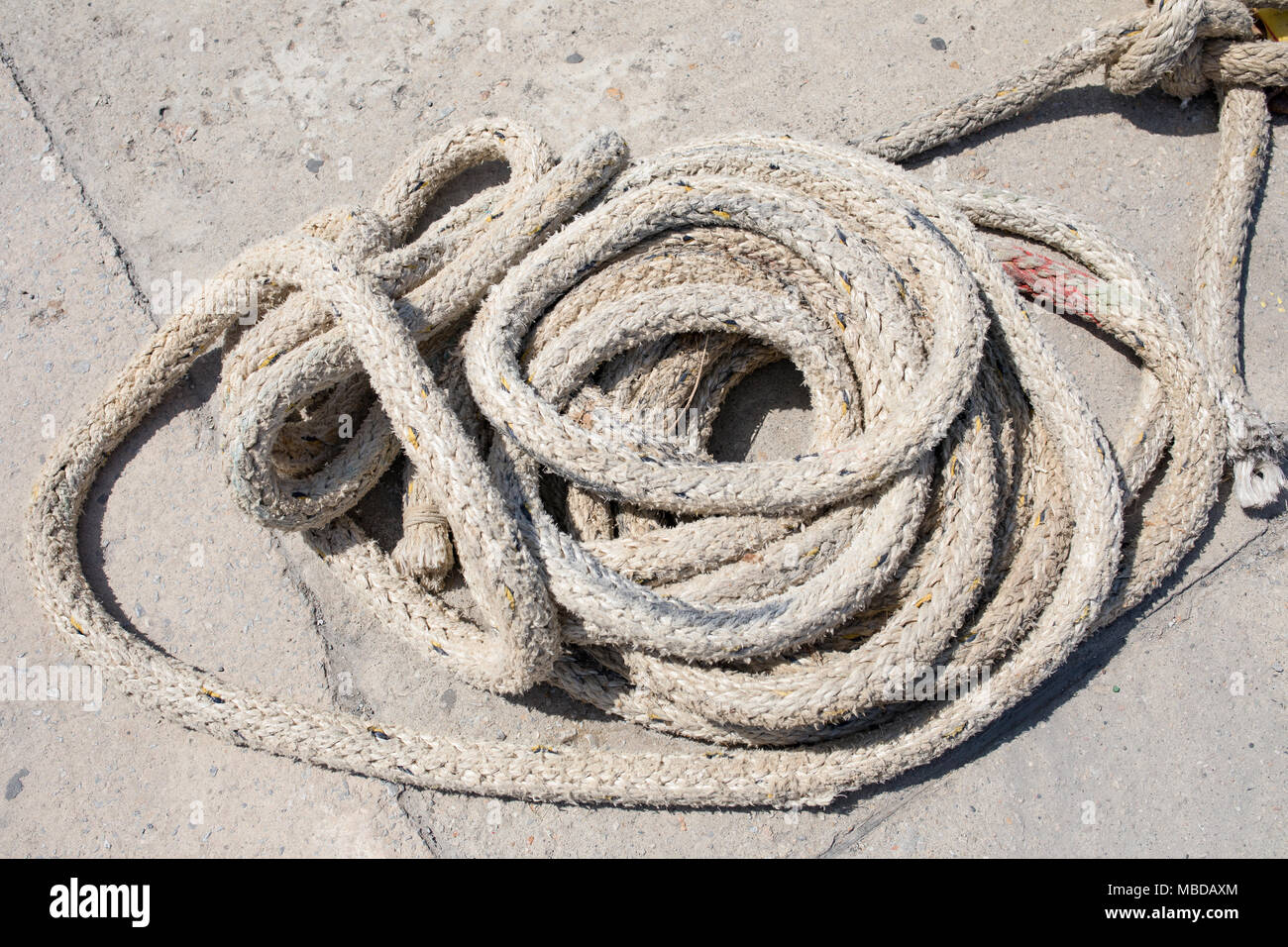 Line, rope, mooring in a greek harbor laying down on a concrete piers