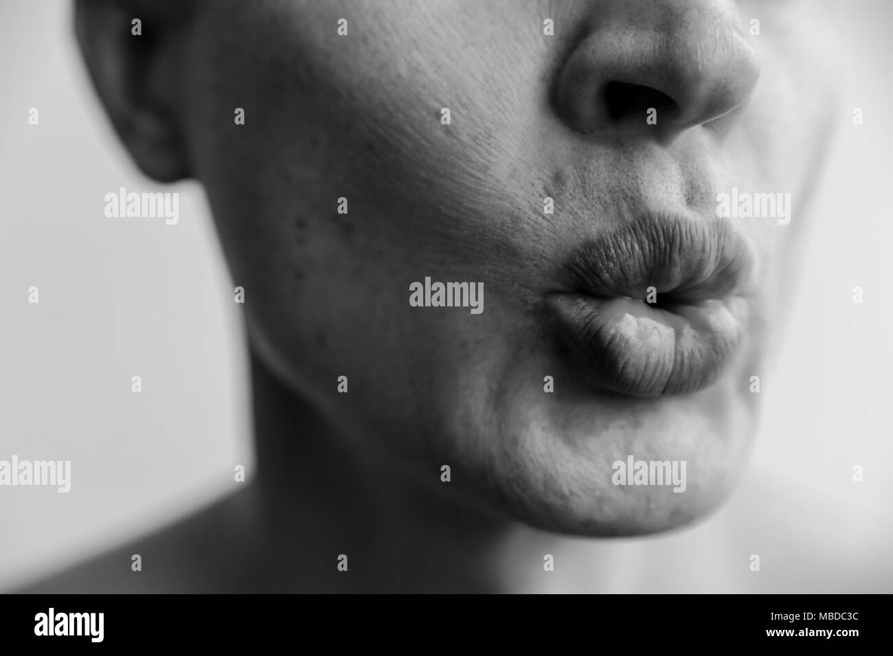 Lips ready for kiss. The lower part of the face of a man  closeup. Black and white images. Stock Photo