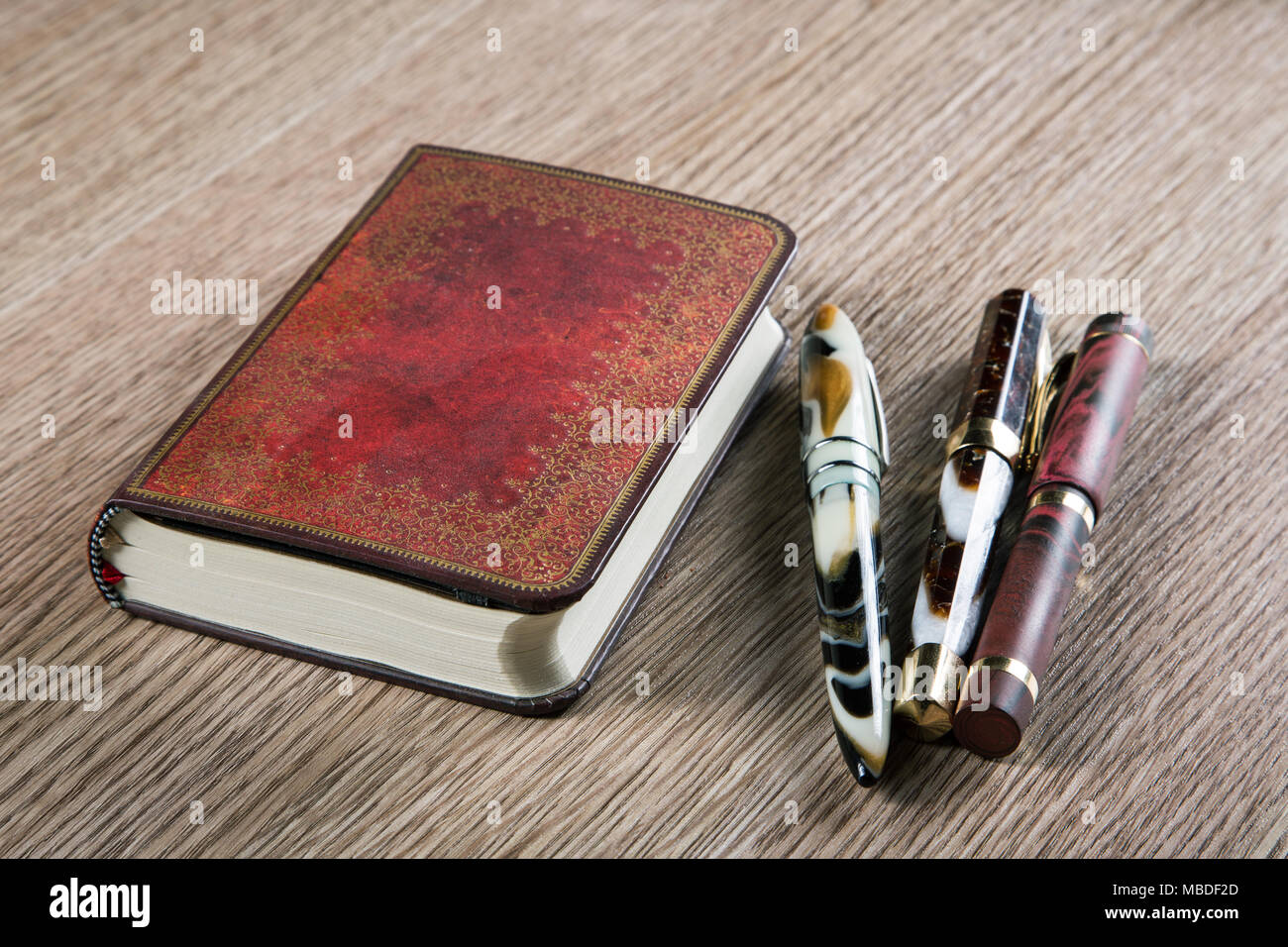 three fountain pens and diaries with leather cover Stock Photo