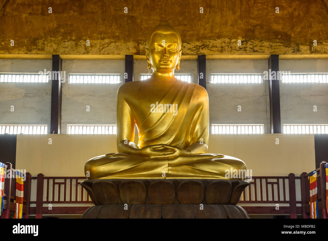 The 10 meters tall golden statue of Buddha in a Lotus pose, seated in the Great Pagoda of the Bois de Vincennes, is the tallest in Europe. Stock Photo