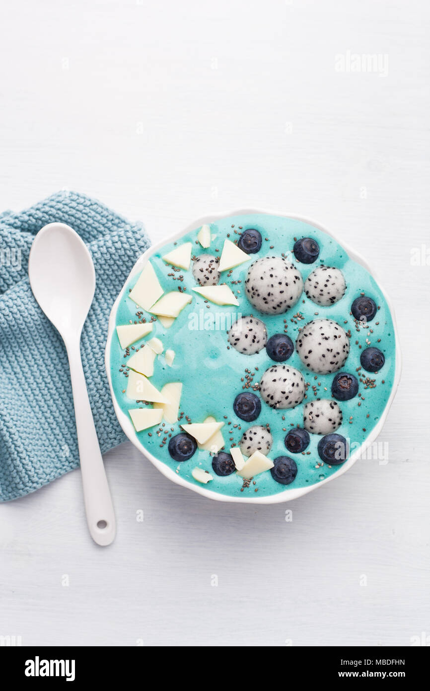 healthy blue spirulina smoothie bowl with blueberry, white chocolate