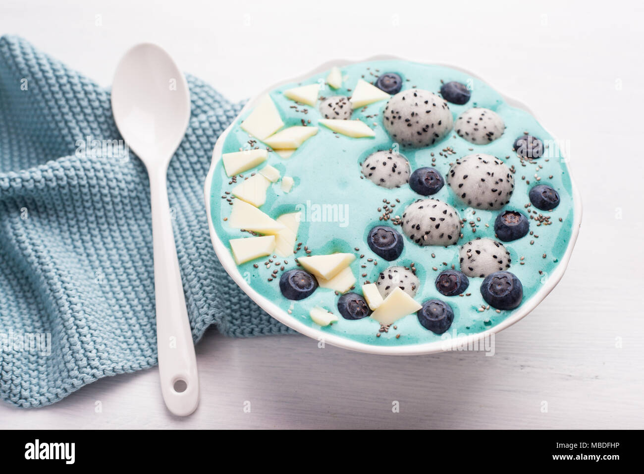 healthy blue spirulina smoothie bowl with blueberry, white chocolate
