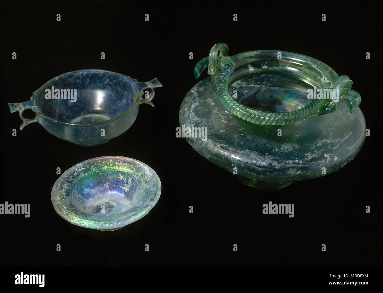 Roman glass set, 1st century AD. From left to right: plate, drinking cup (scyphos) and biconical bowl with twisted handle. National Museum of Roman Art. Merida, province of Badajoz, Extremadura, Spain. Stock Photo