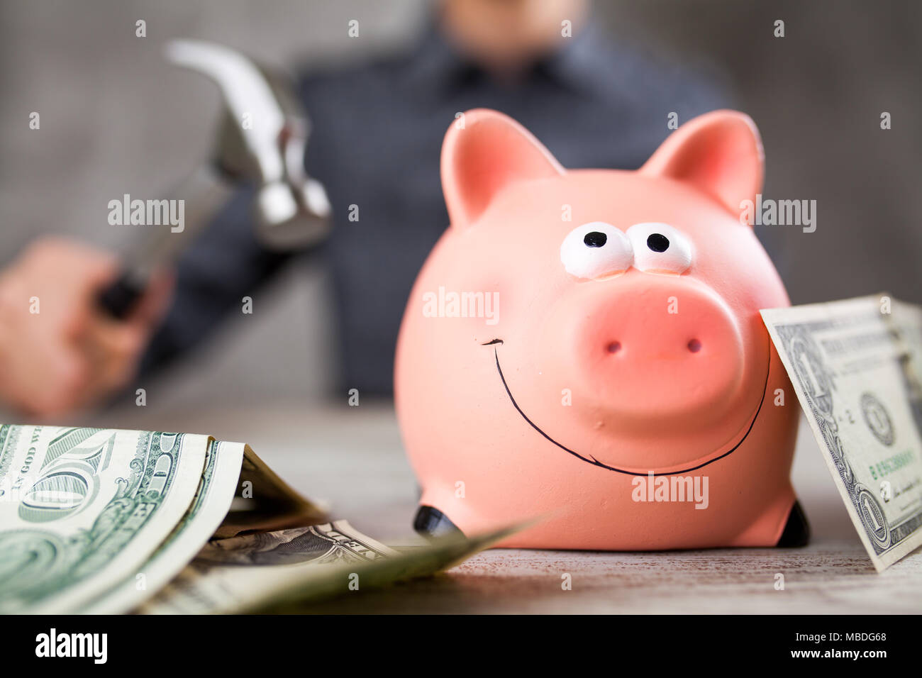 Man holding a piggy bank Stock Photo - Alamy