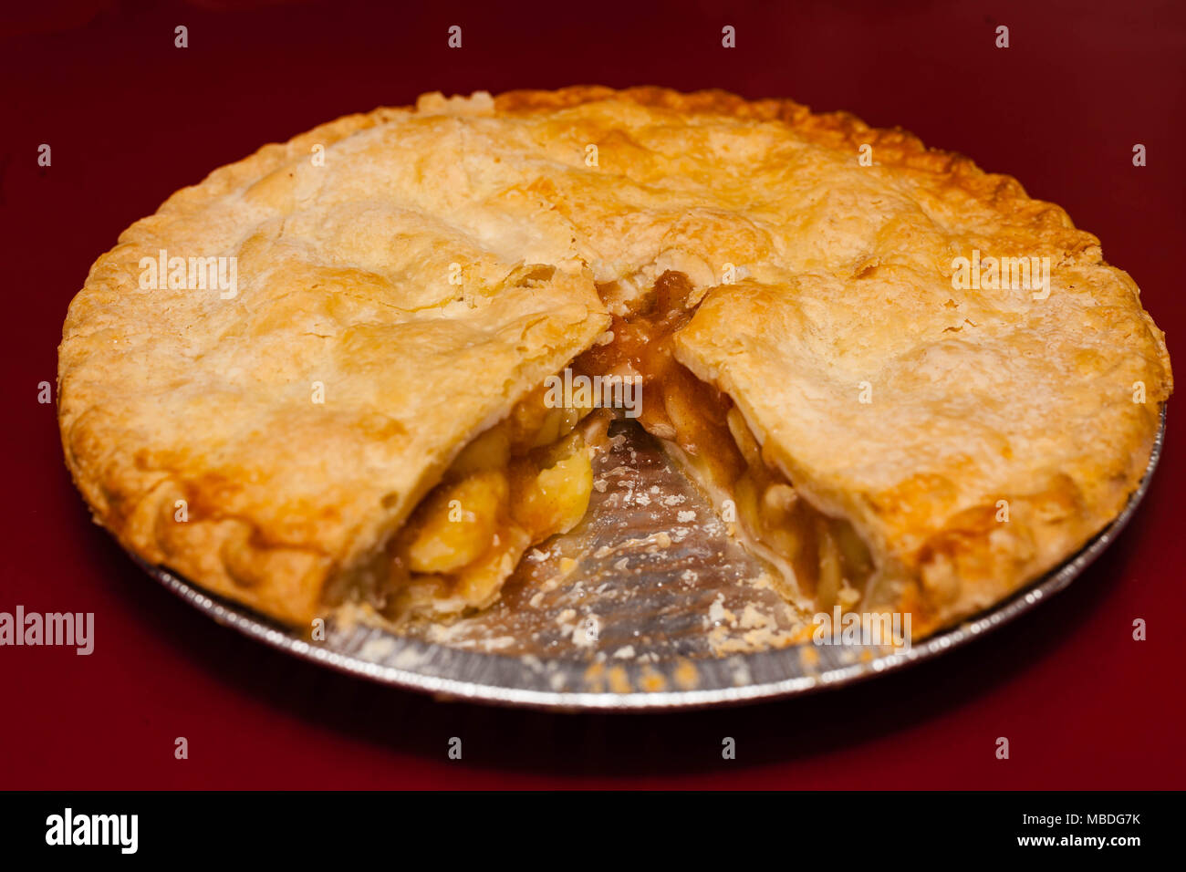 An fresh apple pie with one piece removed Stock Photo
