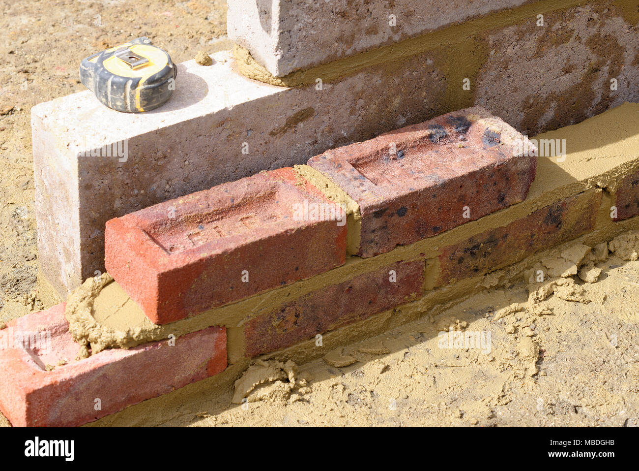 Bricks being laid in wet cement mortar Stock Photo Alamy