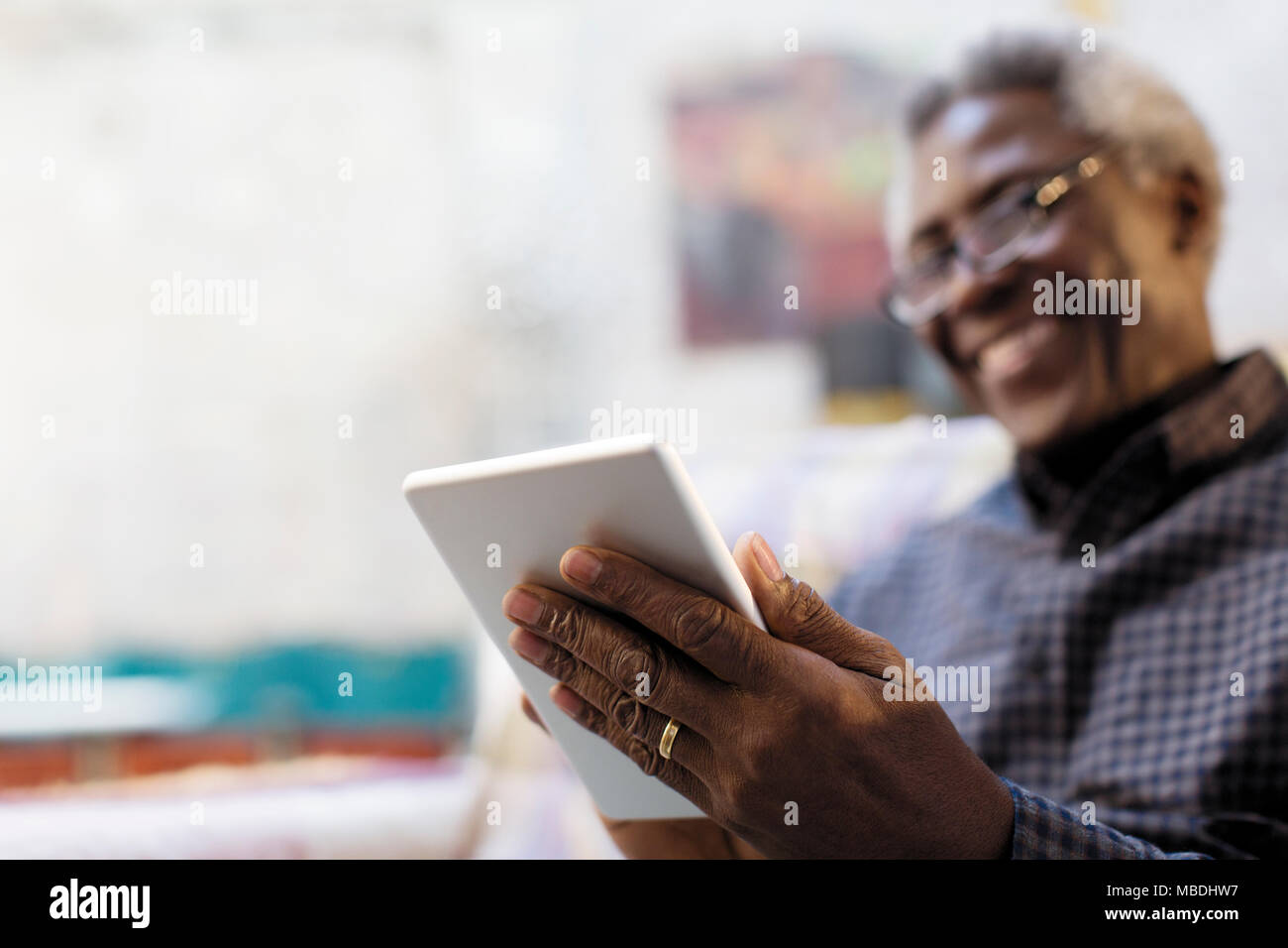 Smiling senior man using digital tablet Stock Photo