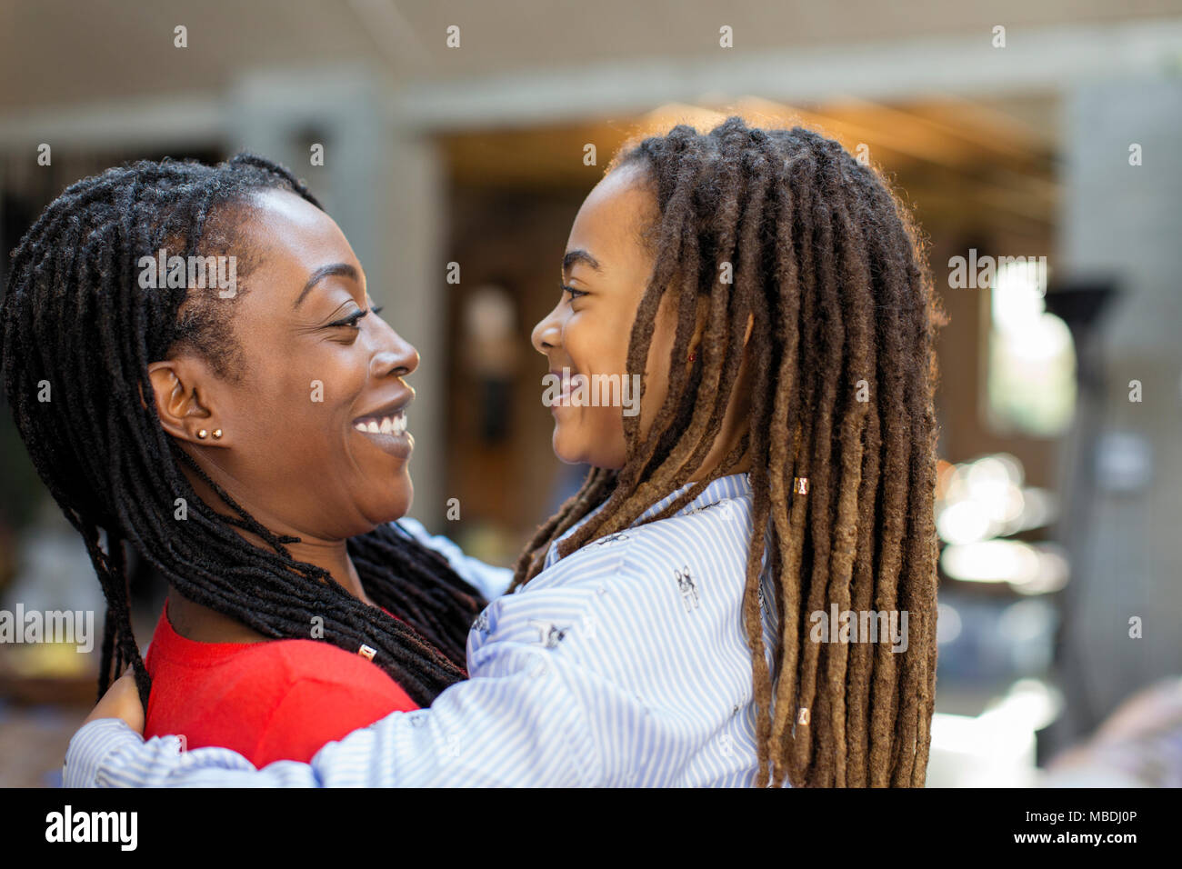Happy mother and daughter hugging face to face Stock Photo