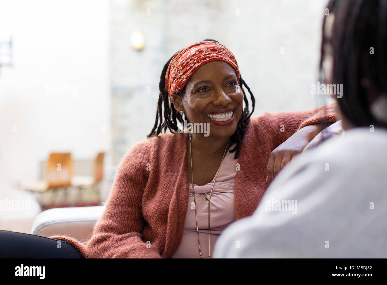 Enthusiastic woman talking with friend Stock Photo