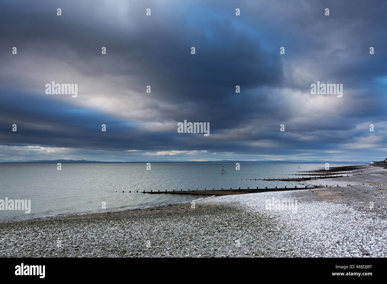 Snow on stormy, remote ocean beach, Silloth, Cumbria, UK Stock Photo