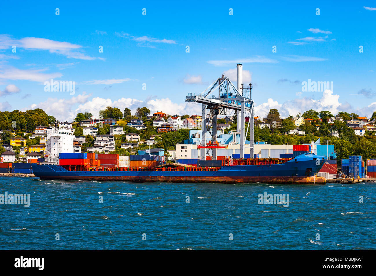 Container ship during loading in port of Moss, Norway. Stock Photo