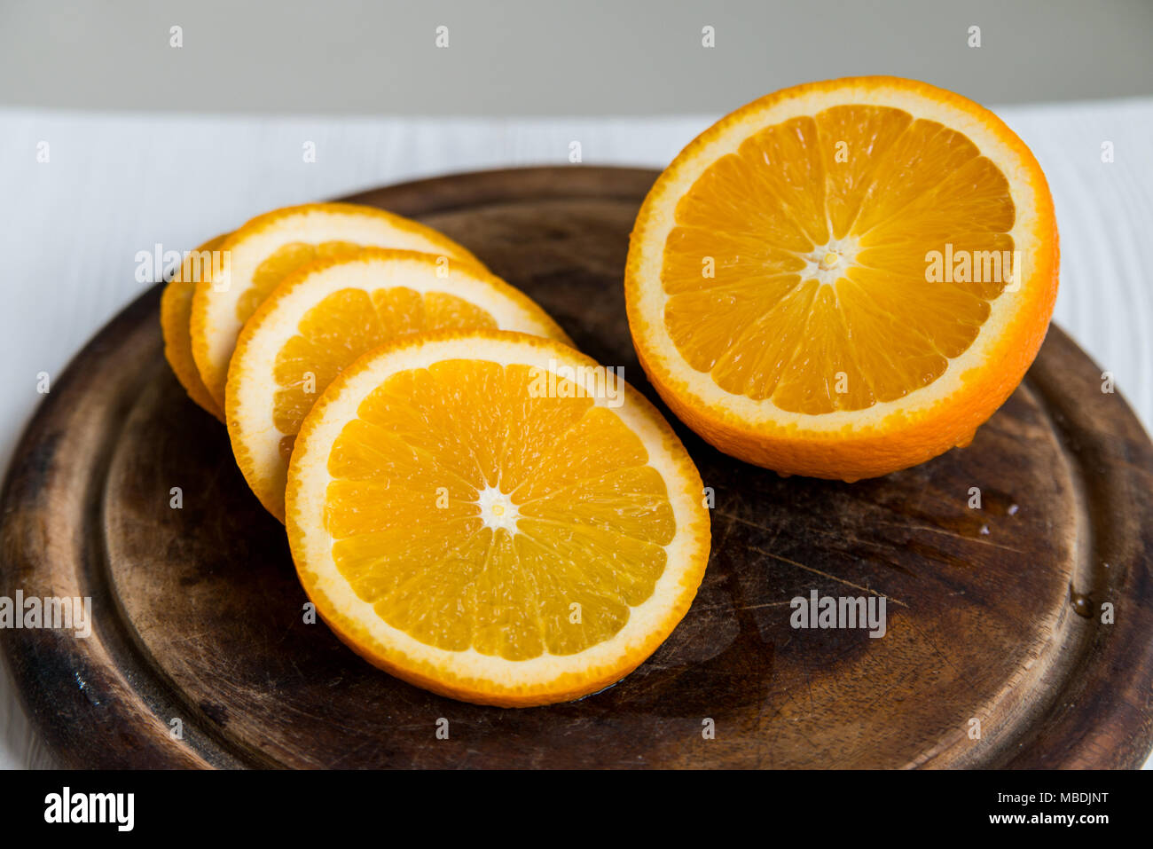Sliced orange on cutting board close Stock Photo