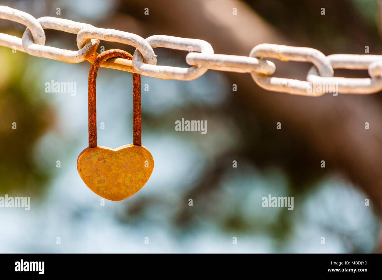 Heart shape lock on rusty chain Stock Photo