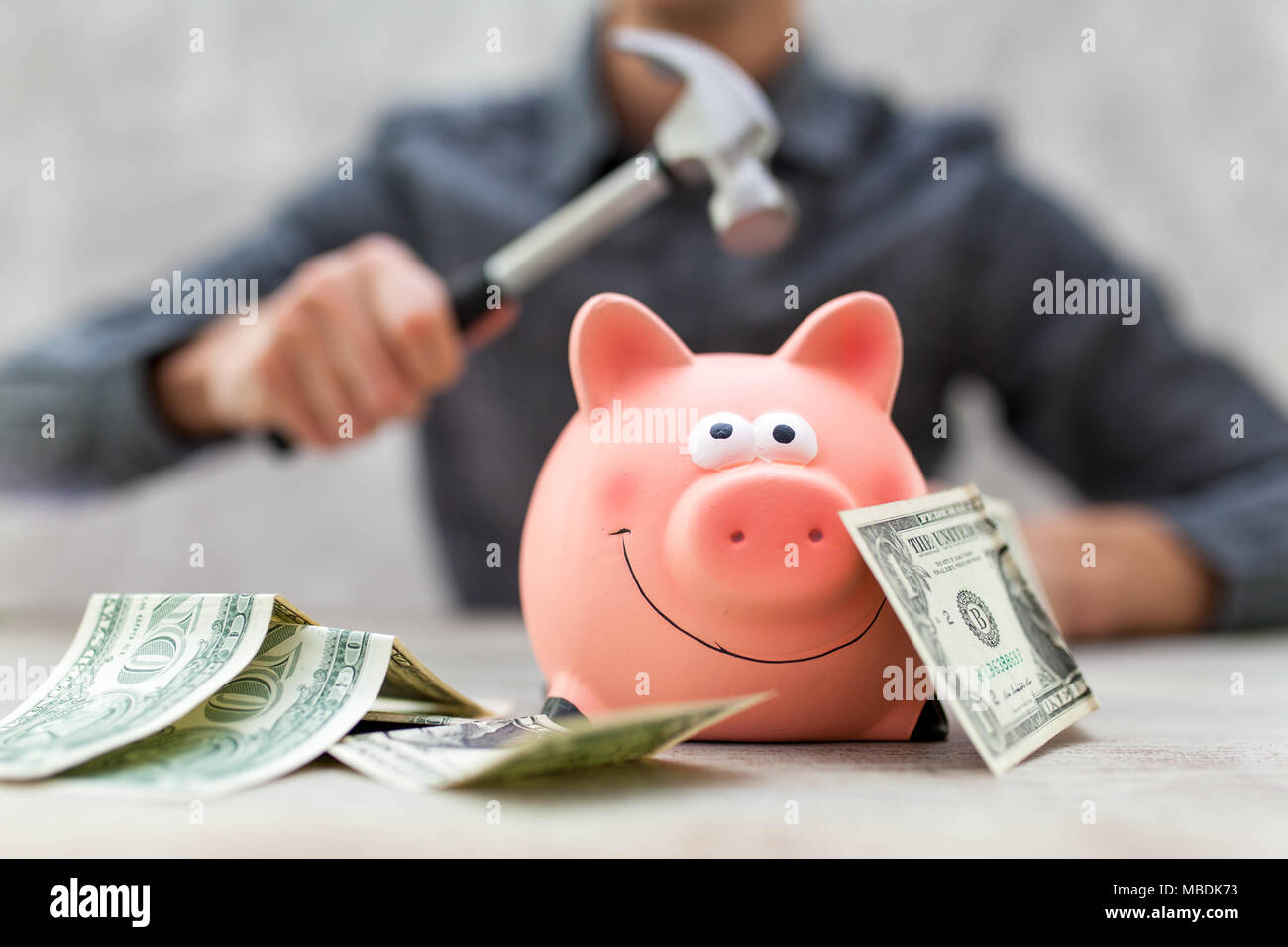 Man piggy bank hammer hi-res stock photography and images - Alamy