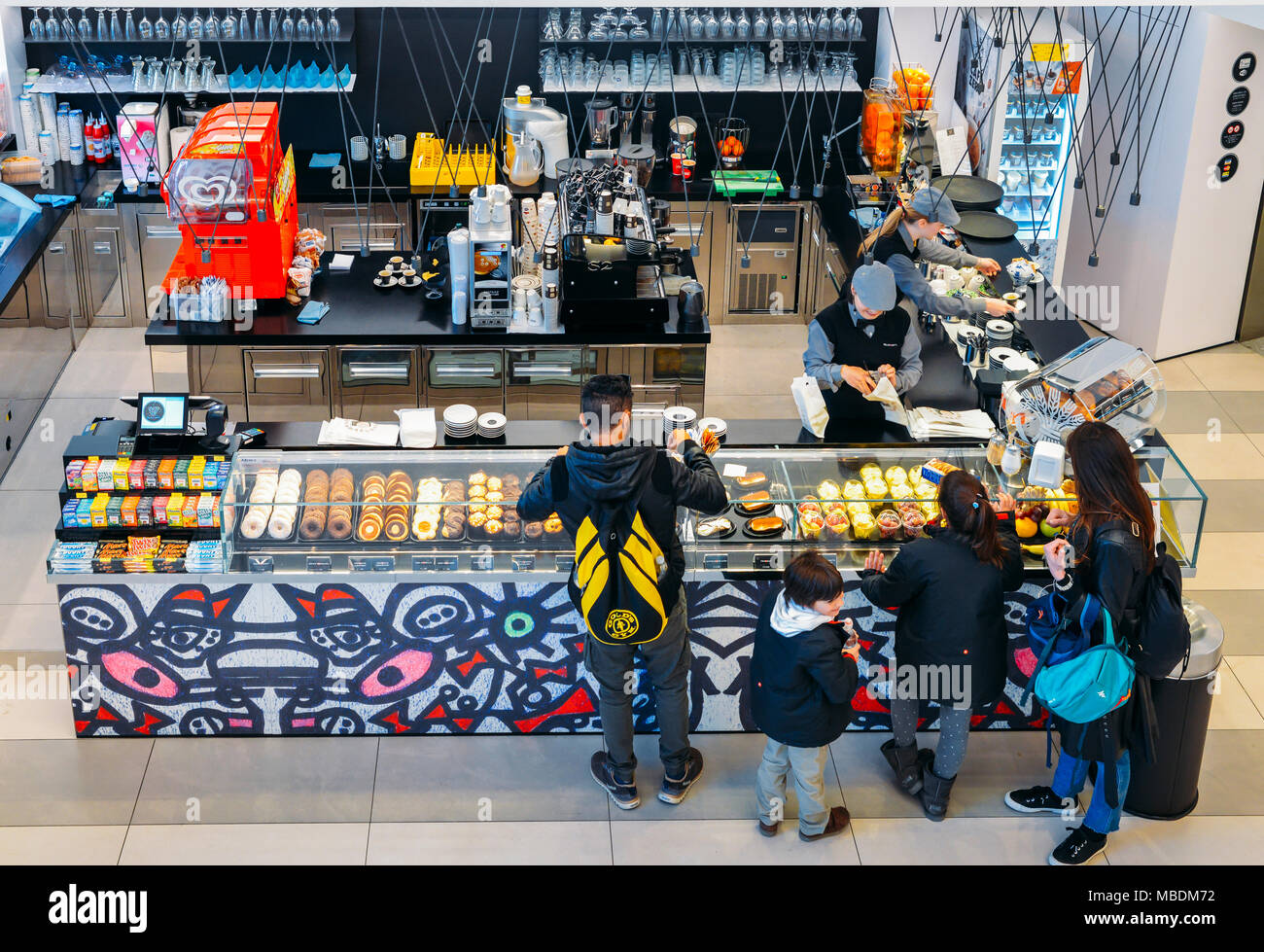 Looking down view of customers at a snack bar counter of Italian sweets