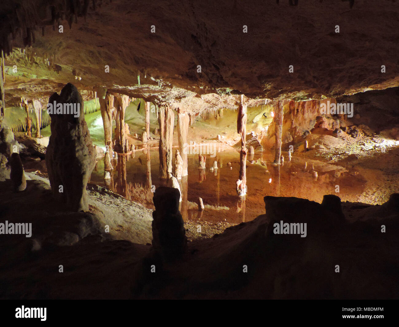 Dripstone cave with subterranean lake or pools.Illuminated cave on Ibiza Island. Stock Photo