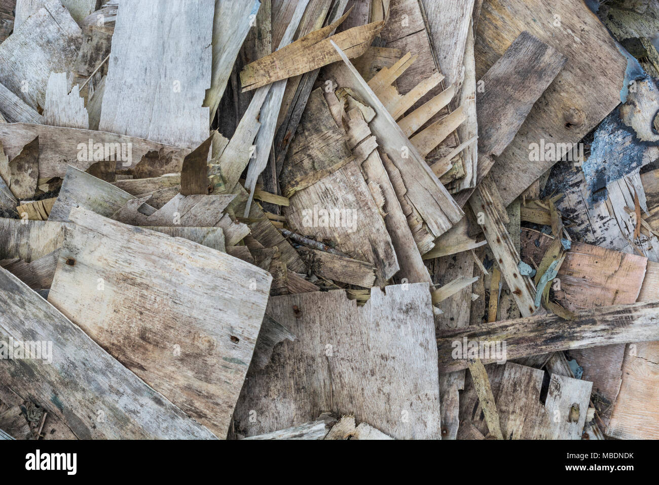 Pile of plywood pieces which are rotting / decaying and falling apart and flaking. Stock Photo