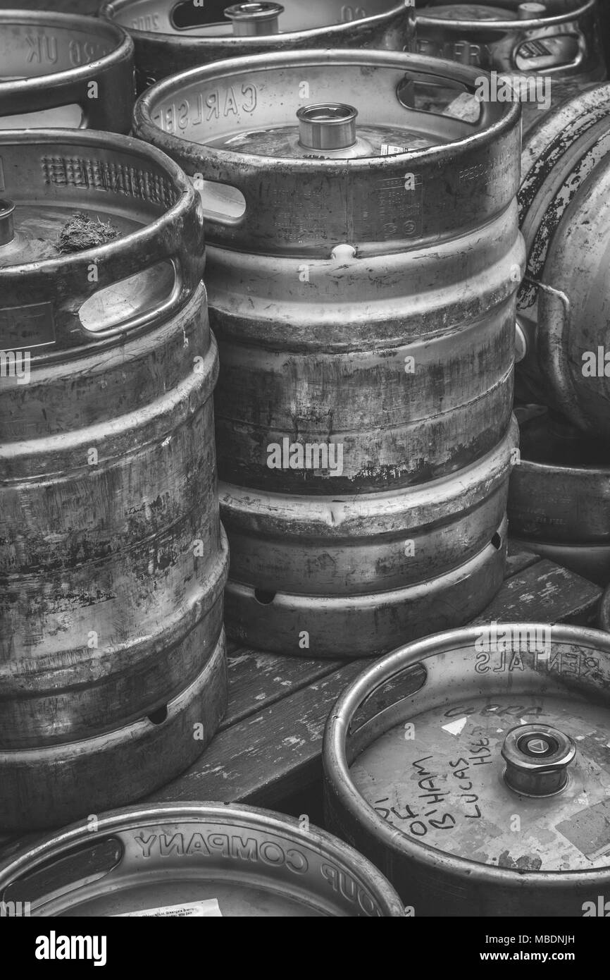 Black and white image of a group of aluminium beer kegs - metaphor for the pub trade, beer drinking, pub wet sales. Stock Photo