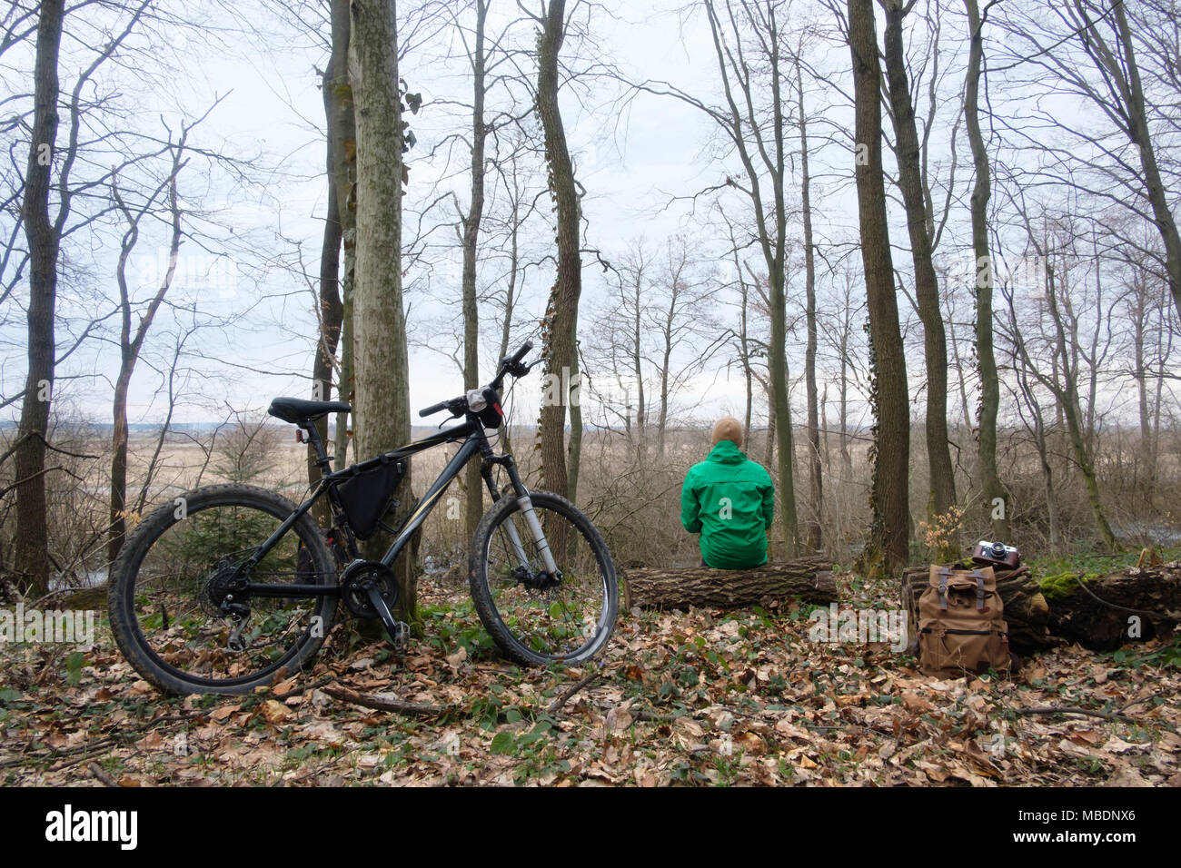Man with bike in wild forest Stock Photo