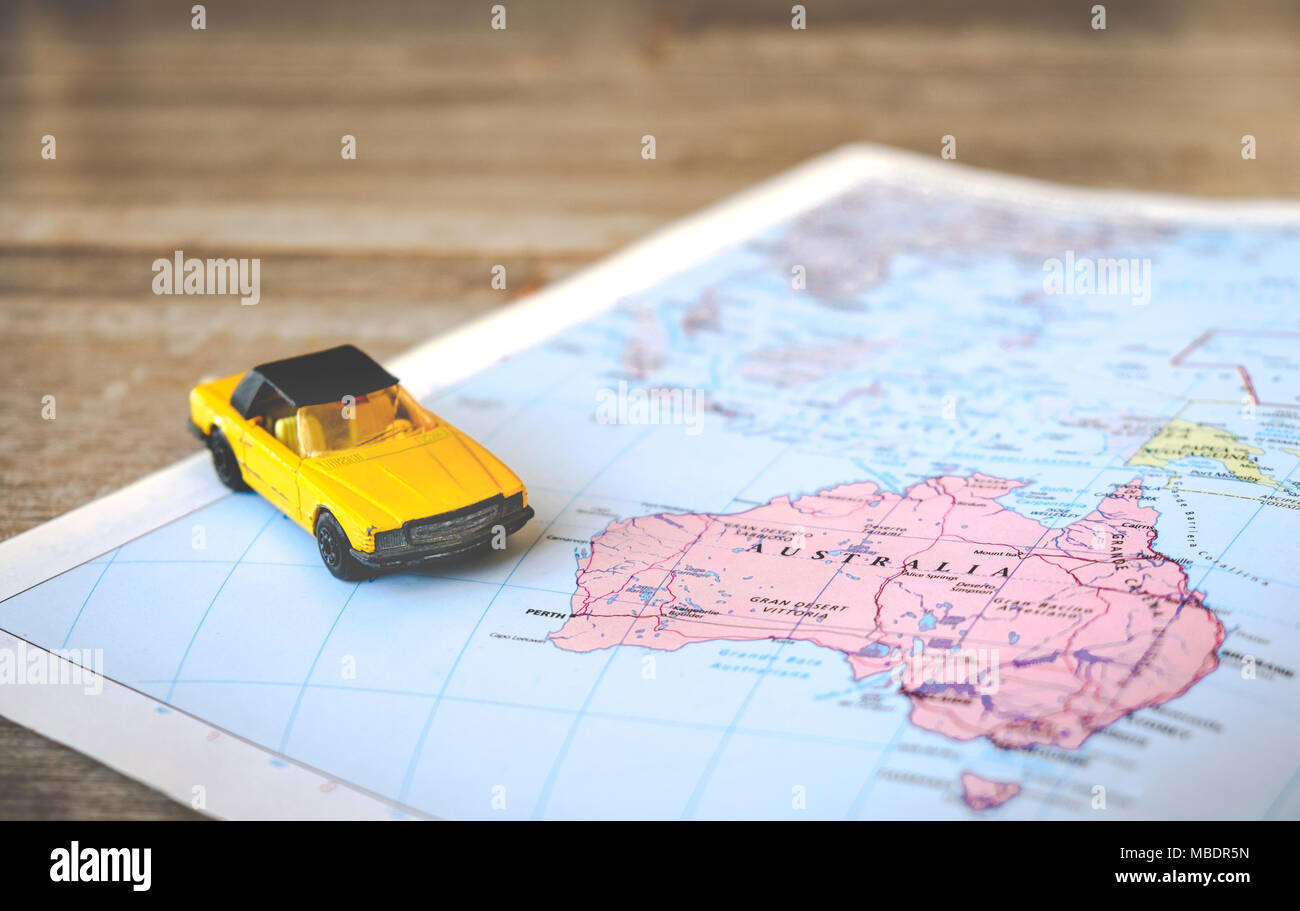 geographic Australia map with yellow convertible car Stock Photo