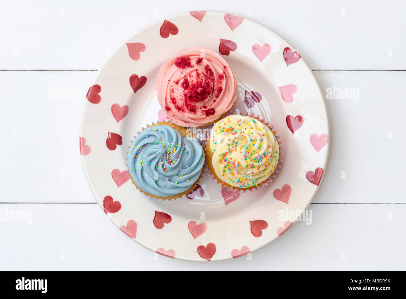 Colourful cupcakes on a heart pattern plate Stock Photo