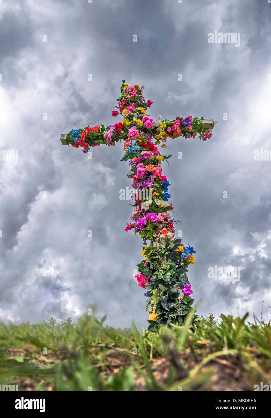 Easter Cross covered with flowers. Stock Photo