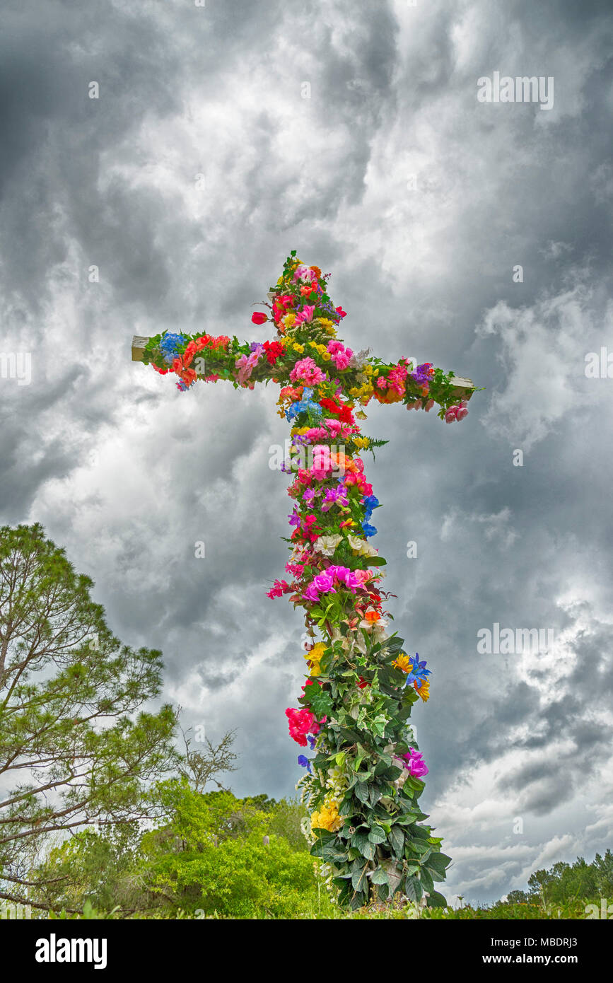 Easter Cross covered with flowers. Stock Photo