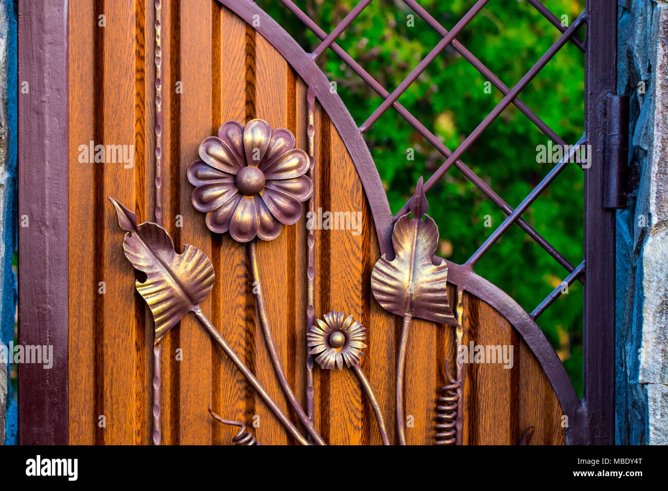 wooden gate with beautiful wrought iron elements flowers Stock Photo ...