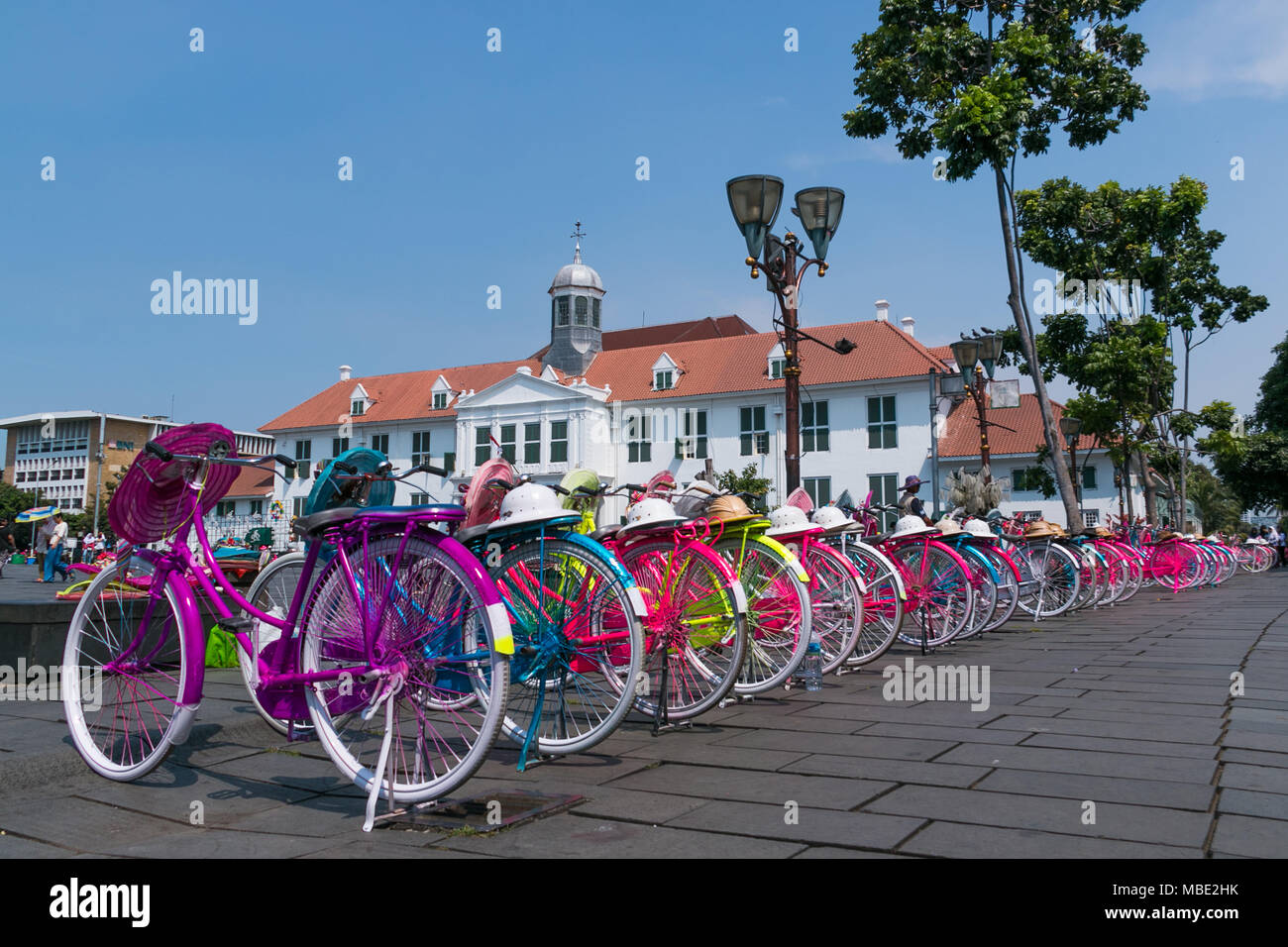 Bicyle and hats rent at Batavia Old City in Jakarta, Indonesia. Rent a multi-colour bicycle and hats for walking around Fatahillah Museum. Stock Photo