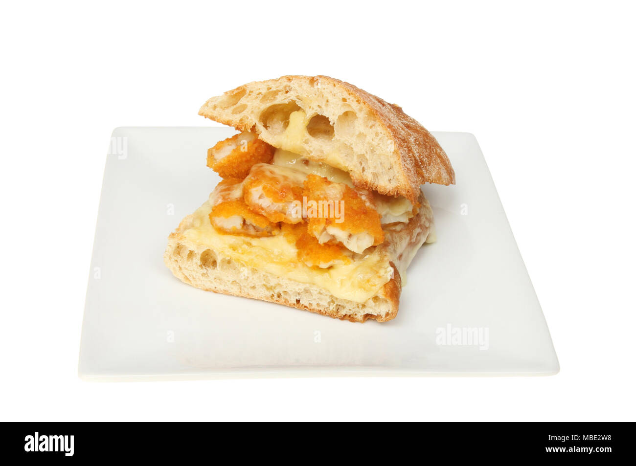 Fish fingers with melted cheese in ciabatta bread on a plate isolated against white Stock Photo