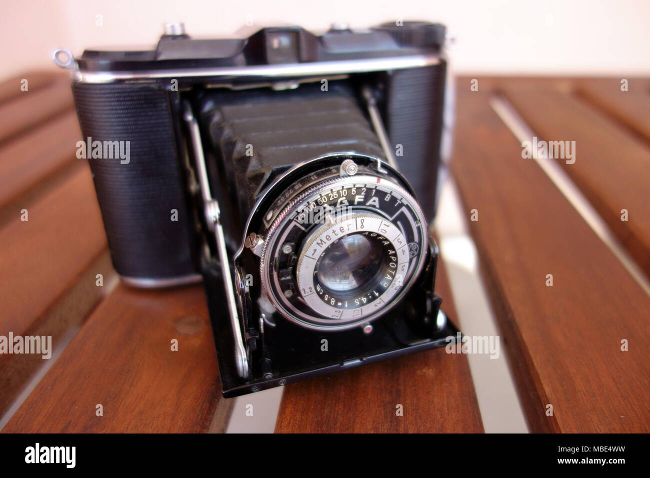 Vintage photo camera with lens contraption open Stock Photo