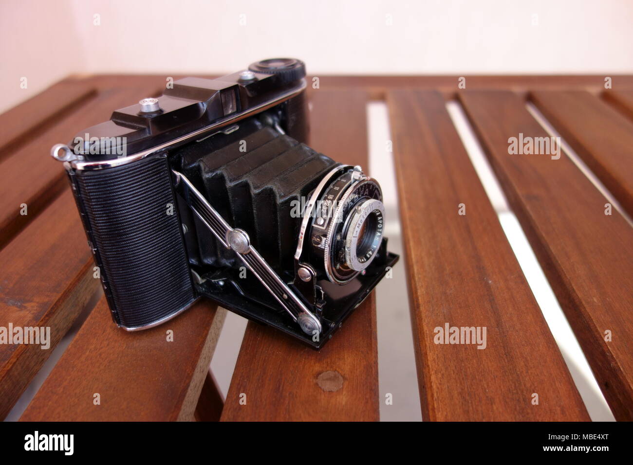 Vintage photo camera with lens contraption open Stock Photo
