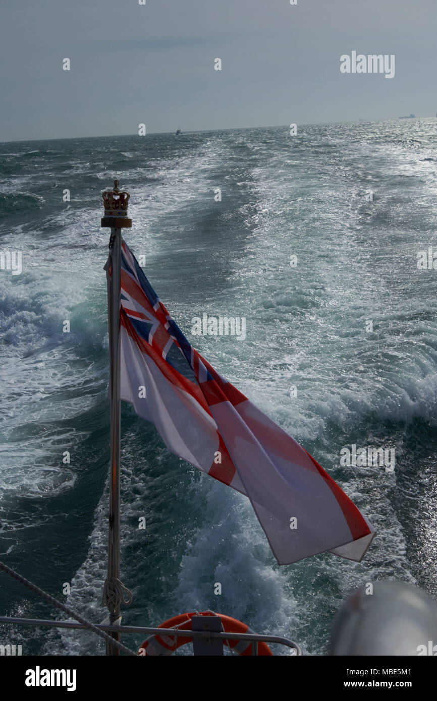 A British White Ensign flying from the back of Royal Navy P2000 HMS Dasher P280 Stock Photo