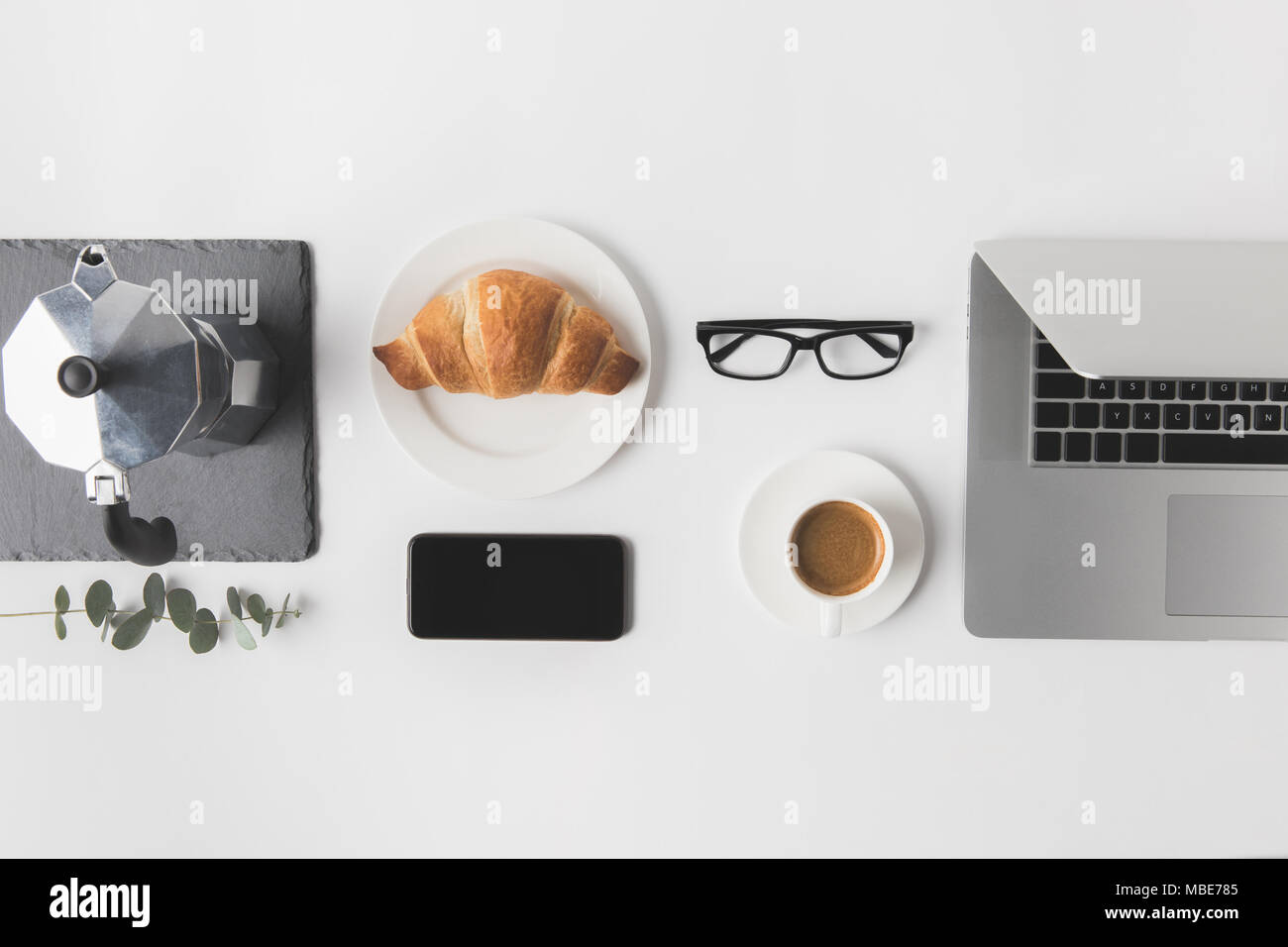 flat lay with digital devices and breakfast on white tabletop Stock Photo