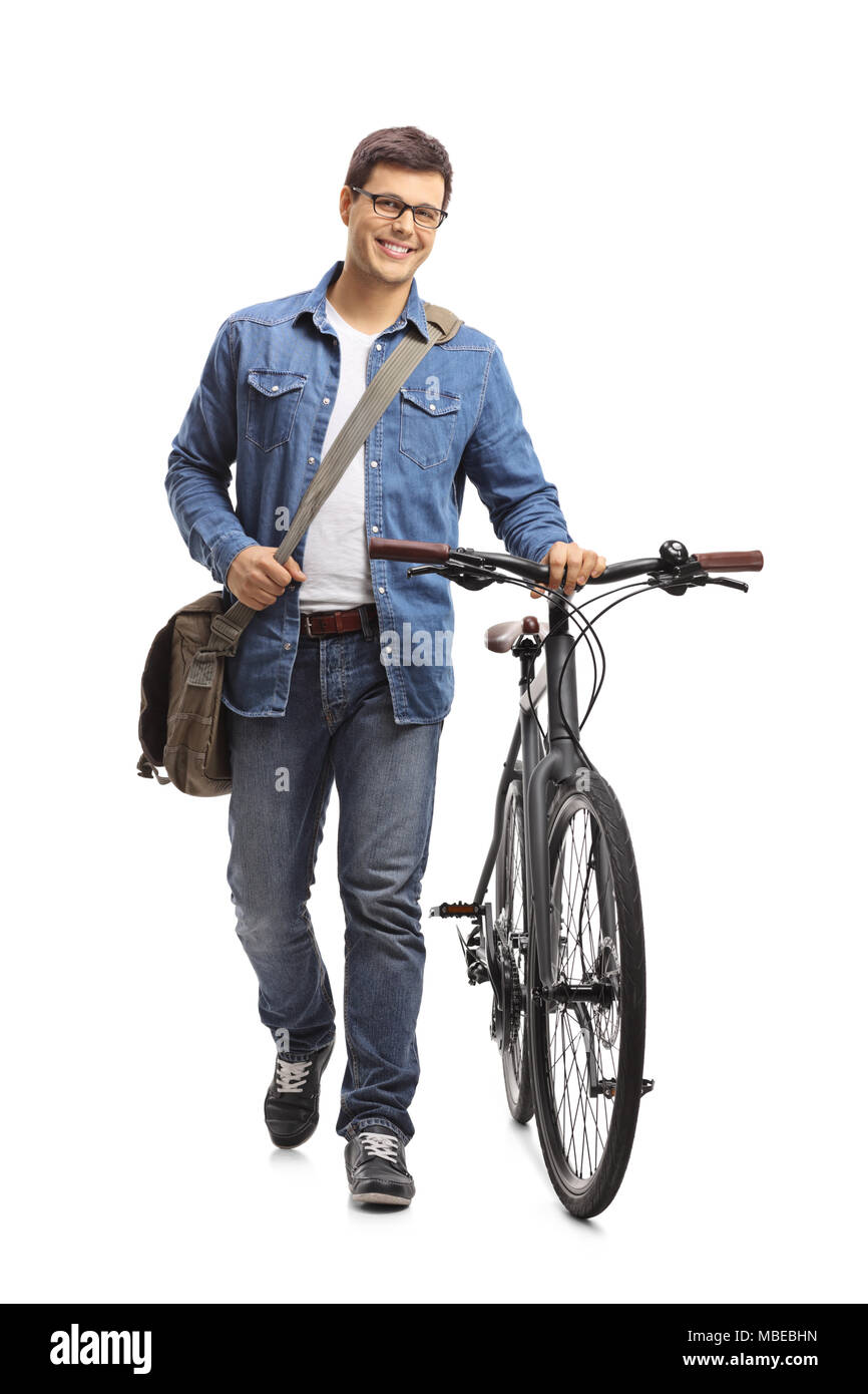 Full length portrait of a young man with a bicycle walking towards