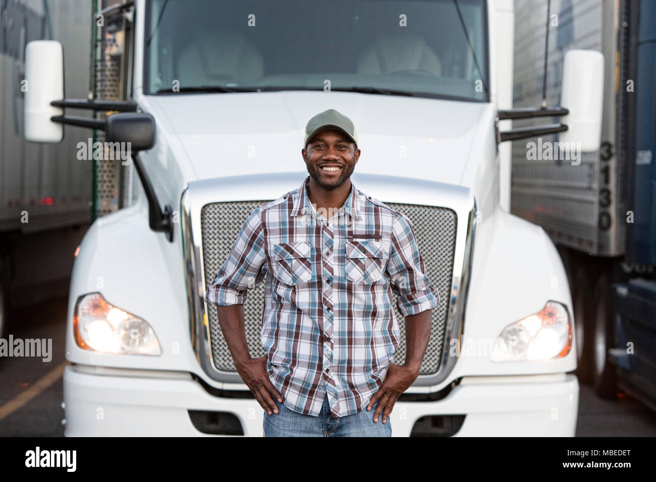 Black Man Truck Driver Near His Truck Parked In A Parking Lot At A