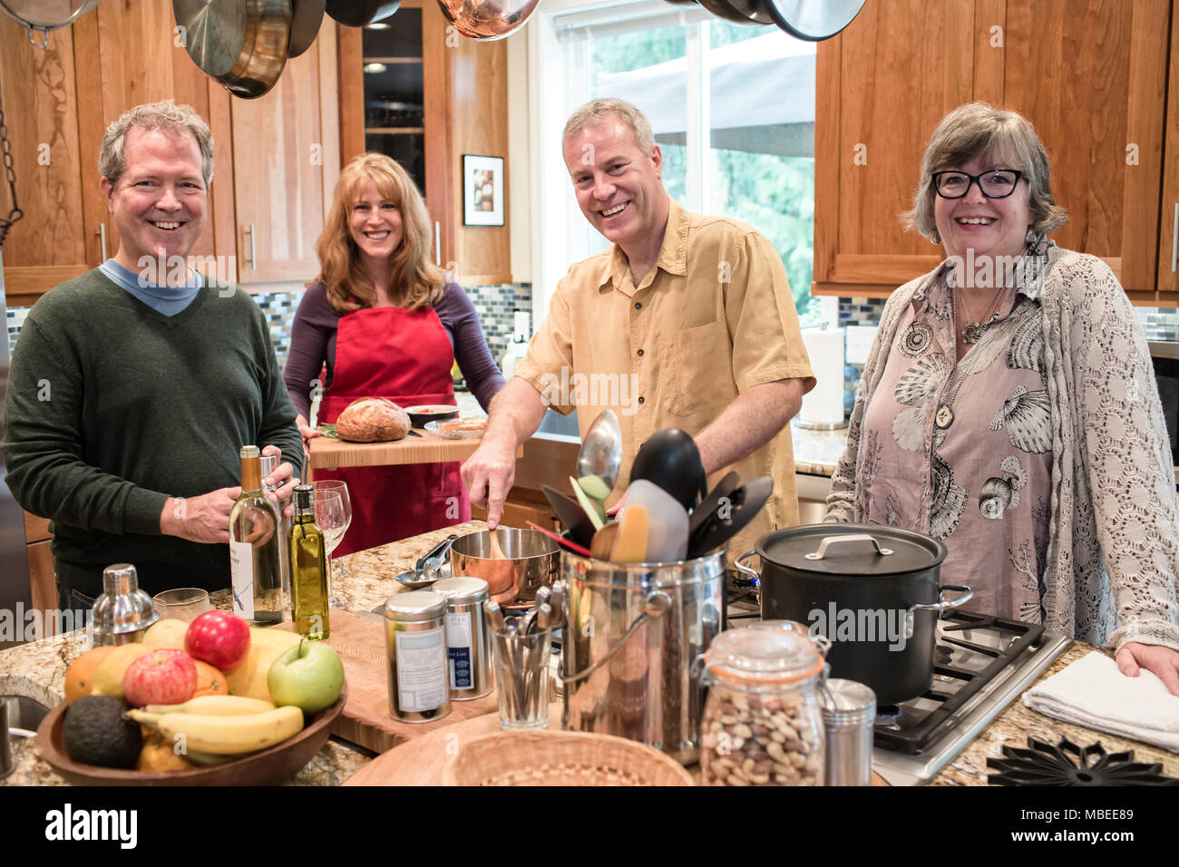 Two senior couples getting together for a dinner party. Stock Photo