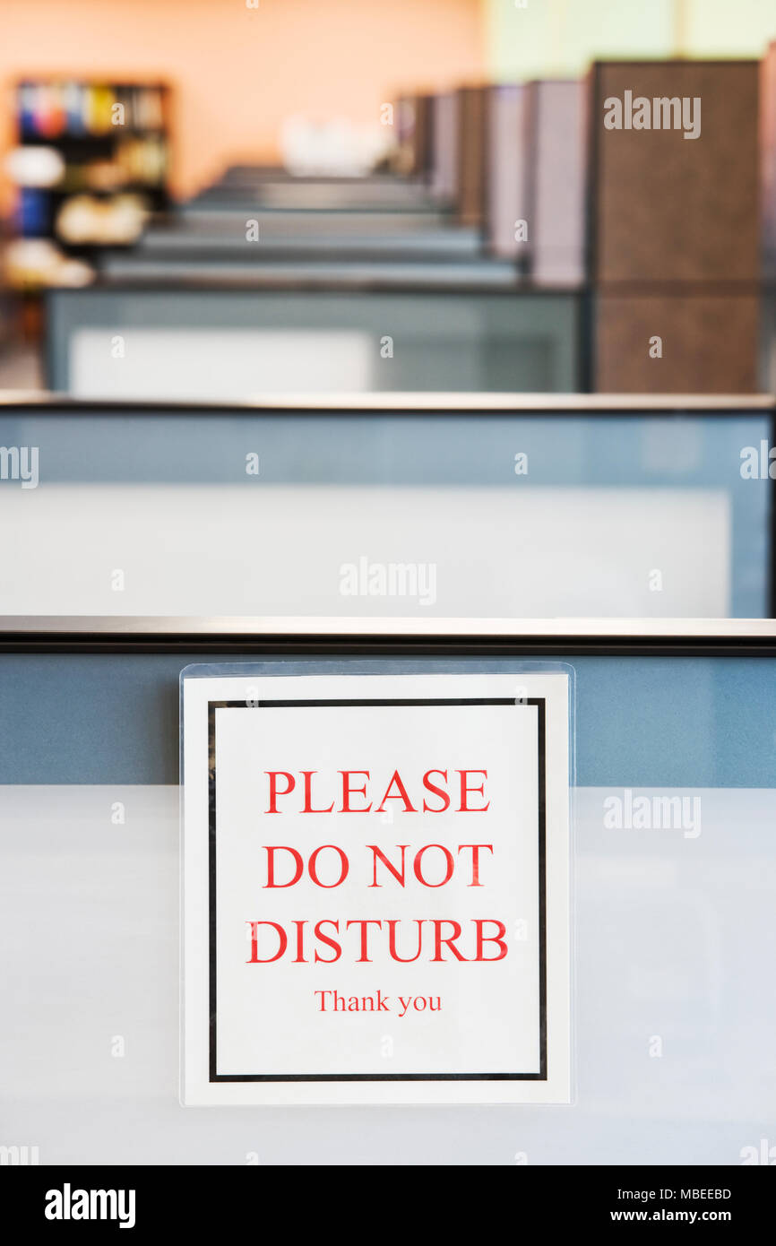 Do Not Disturb Sign Hung On The Wall Of A Cubicle In An Office