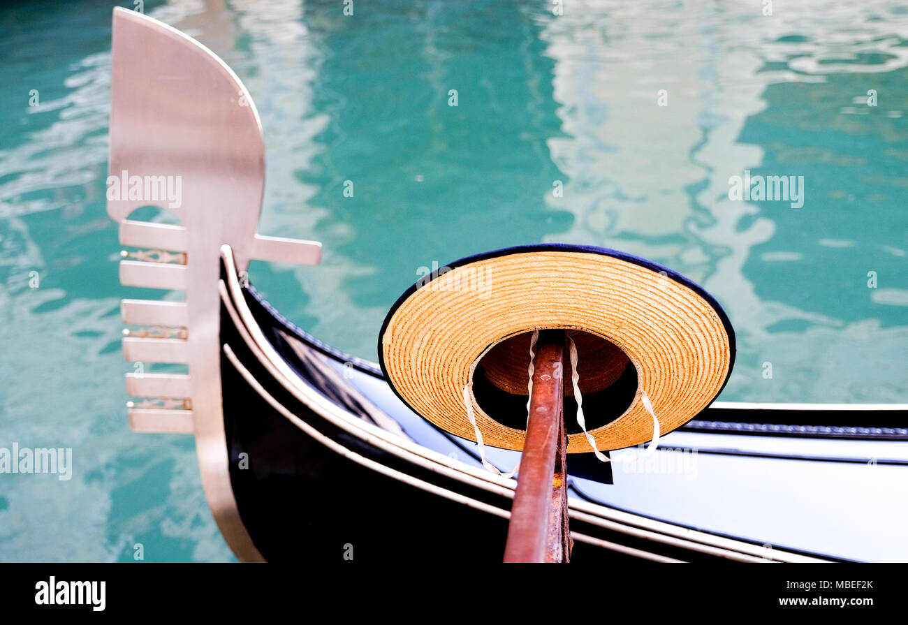 Gondoliers straw boater hat and the bow of a Gondola in Venice Italy Stock Photo